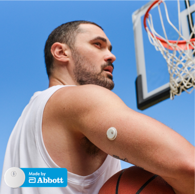 MiniMed Champion Rob holding basketball with Instinct sensor on arm